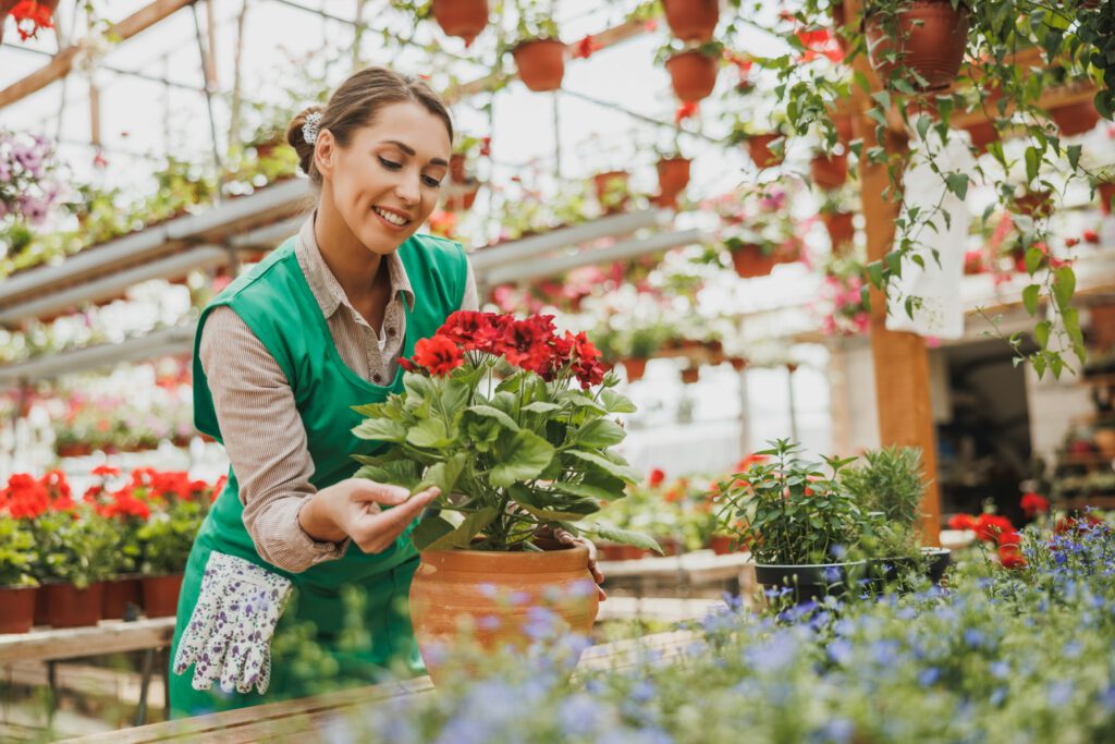 Woman Entrepreneur Care About Flowers In Garden Center